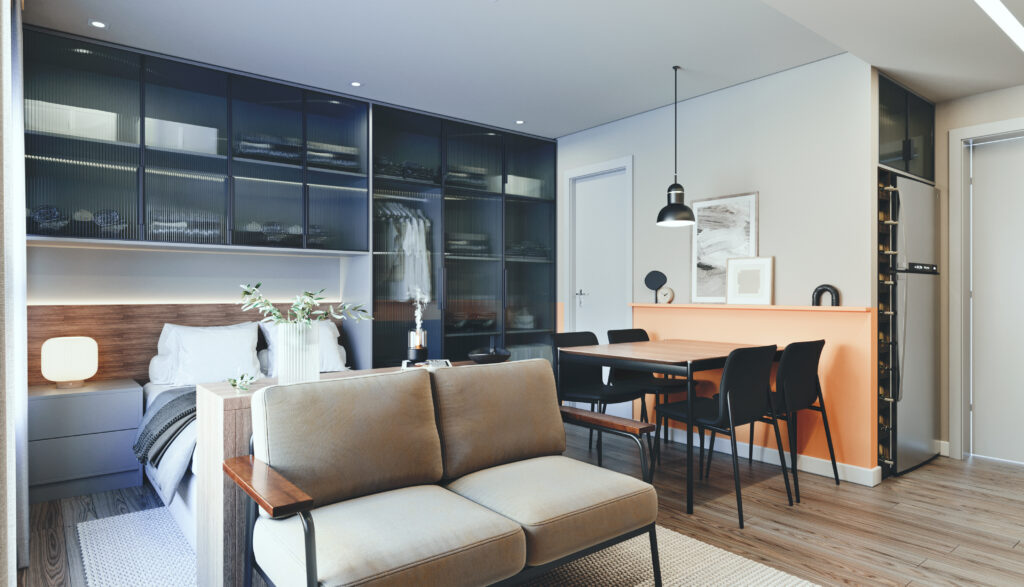 Studio moderno com cama, sofá, armários de vidro escuro, mesa de jantar para quatro pessoas e cozinha compacta; ambiente com decoração minimalista.